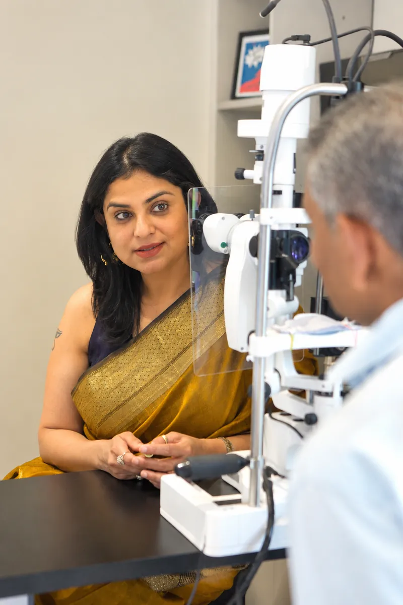 Dr. Anchal Gupta in consultation with a patient at the slit lamp