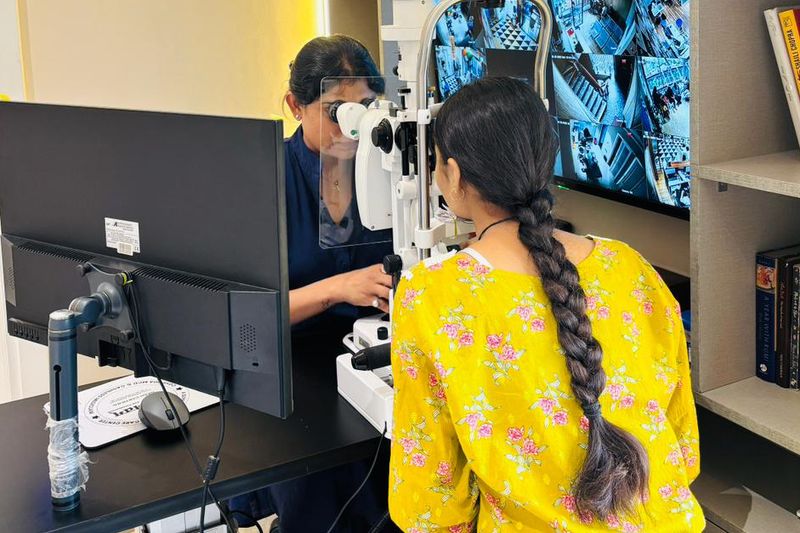 Dr. Anchal Gupta examining a young patient at the slit lamp