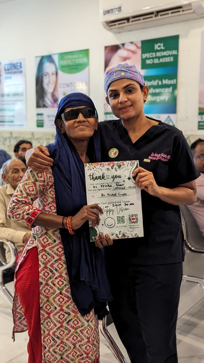 Dr. Anchal Gupta with a patient holding her thank-you certificate after cataract surgery
