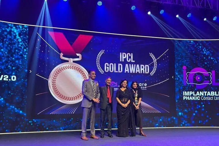 Dr. Anchal Gupta on stage at the IPCL Gold Award ceremony, with the award screen behind
