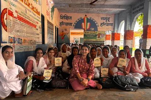 Schoolgirls holding their Roshini screening cards